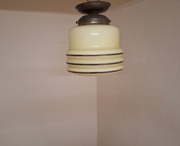 flat art deco german ceiling lamp with original brass mount and beige glass shade with line decoration 1920s 1