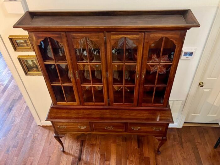 late 20th century vintage colonial style solid cherry china cabinet with bubble glass doors and cabriole legs 2737